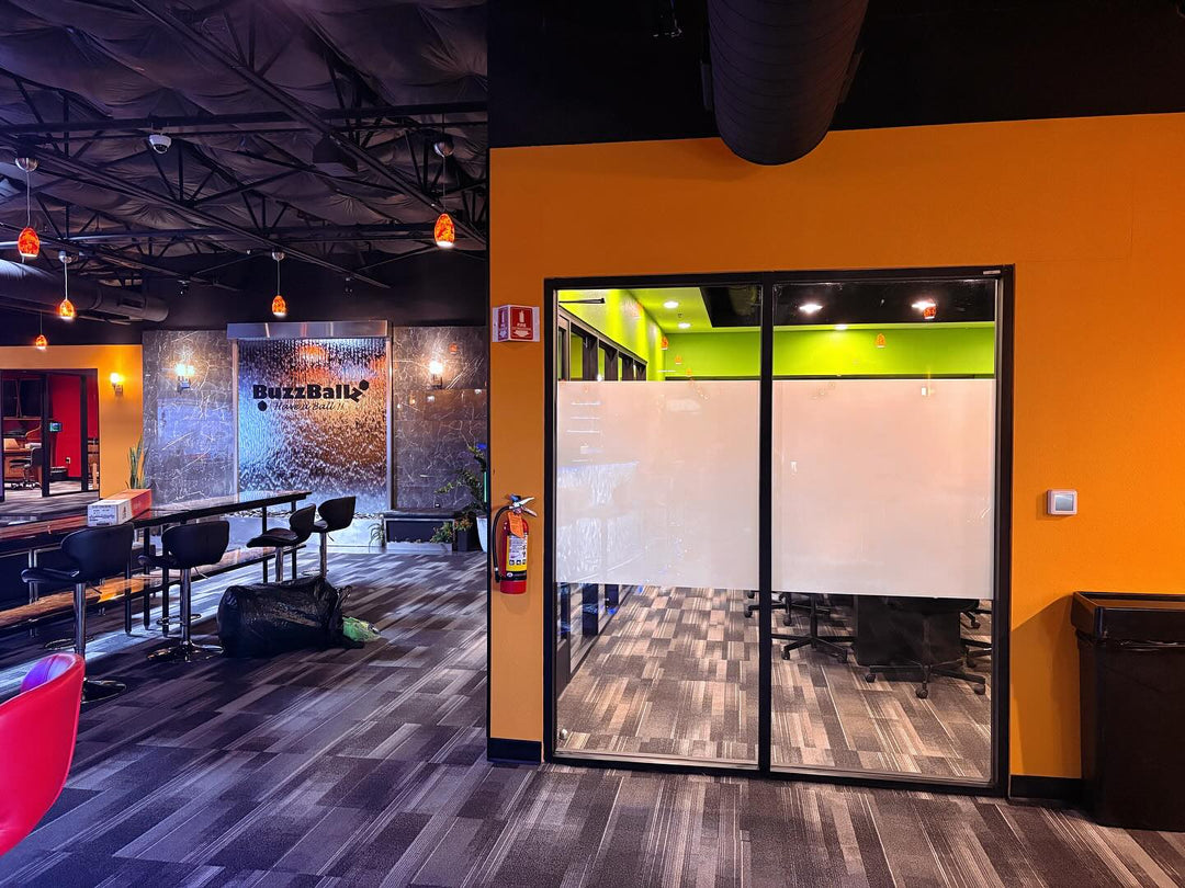 Modern office interior with colorful walls and glass conference room tinted with window film for decor and privacy 