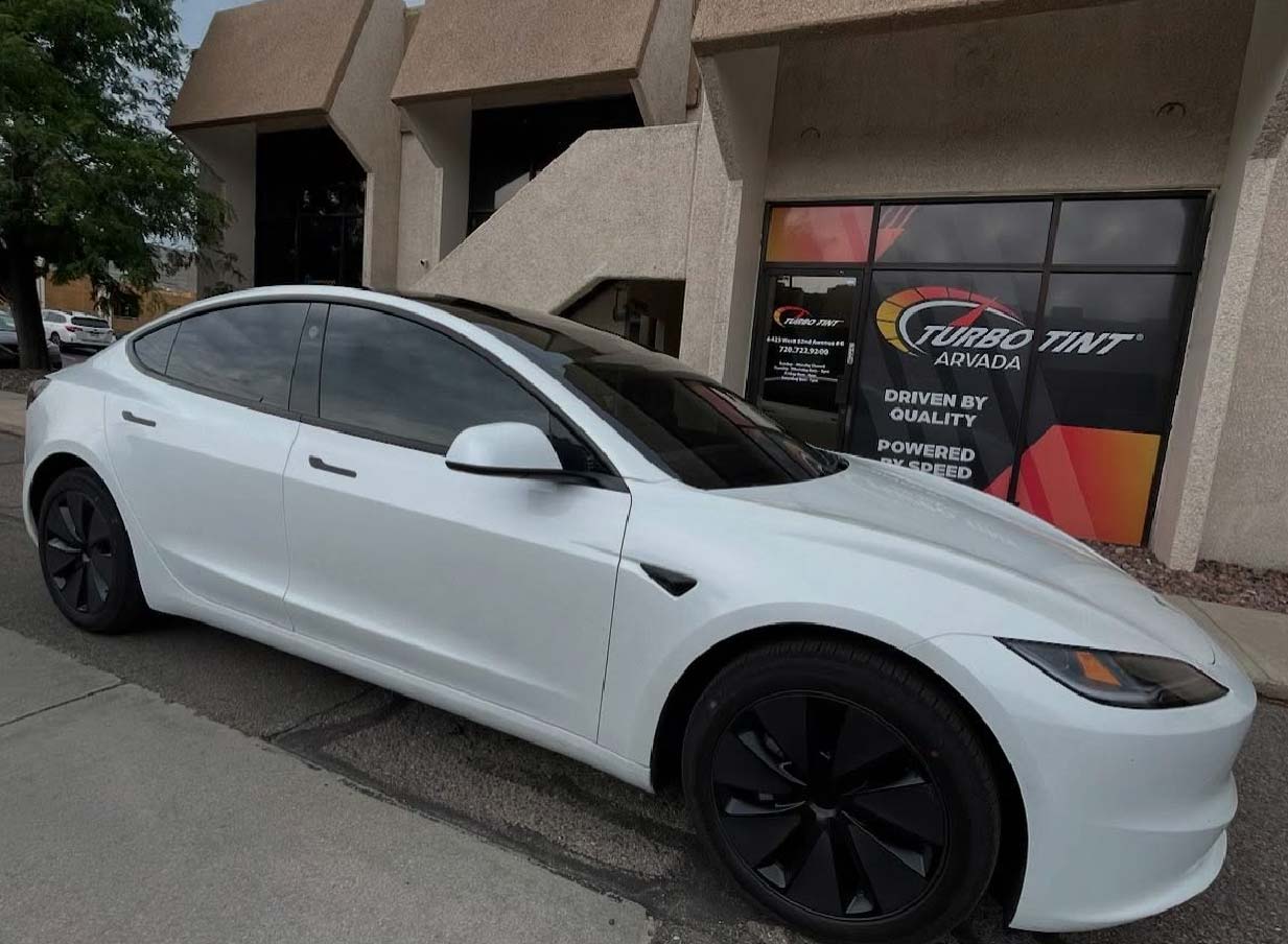 Tesla parked infront of Turbo Tint arvada with new window tint on sunroof and windows