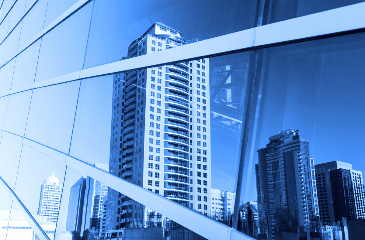 Cityscape reflection in a glass building with window tint for glare and heat protection