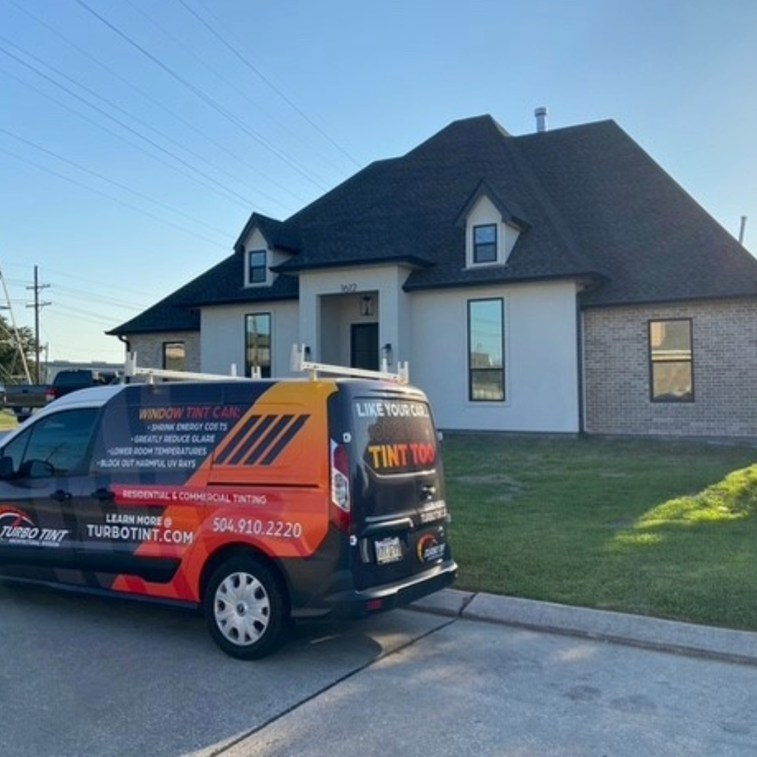 Turbo Tint van parked in front of a house with newly installed window tint 